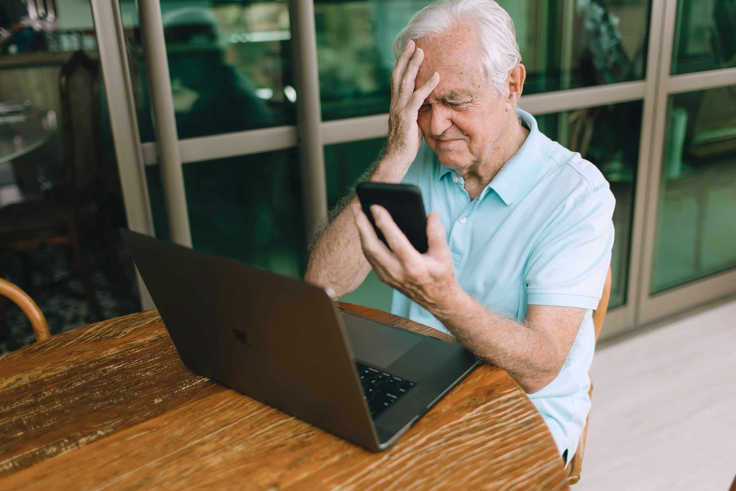 senior sitting in front of laptop