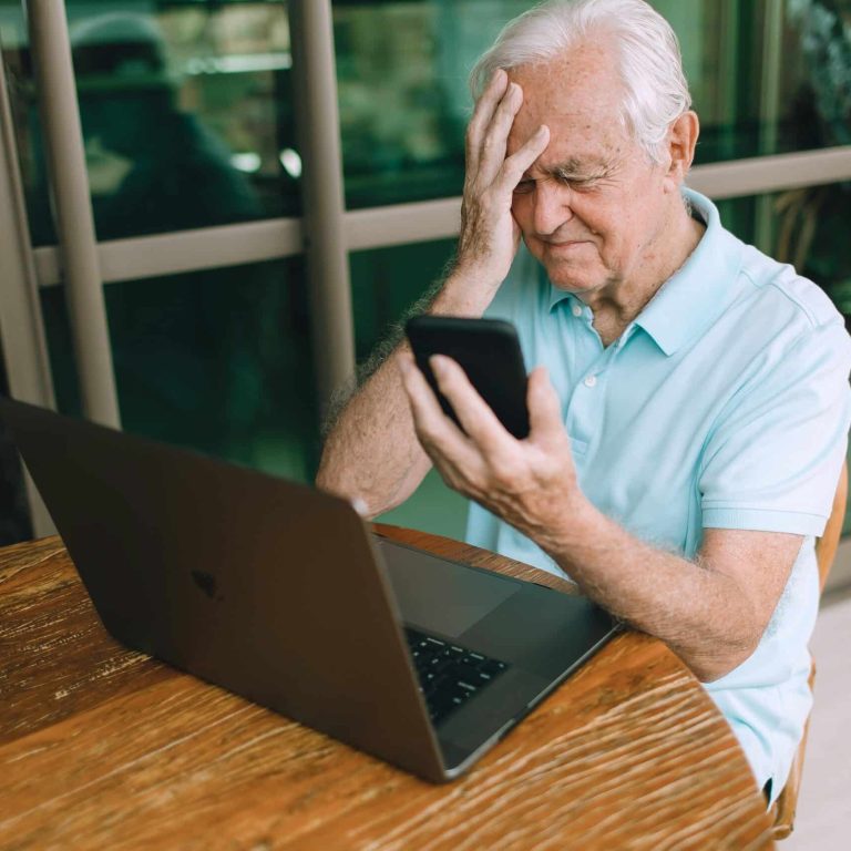 senior sitting in front of laptop
